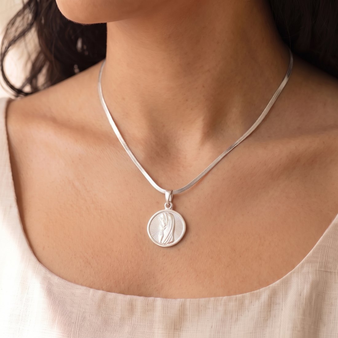 Medalla Virgen Niña en cadena de plata tipo cinta, puesta